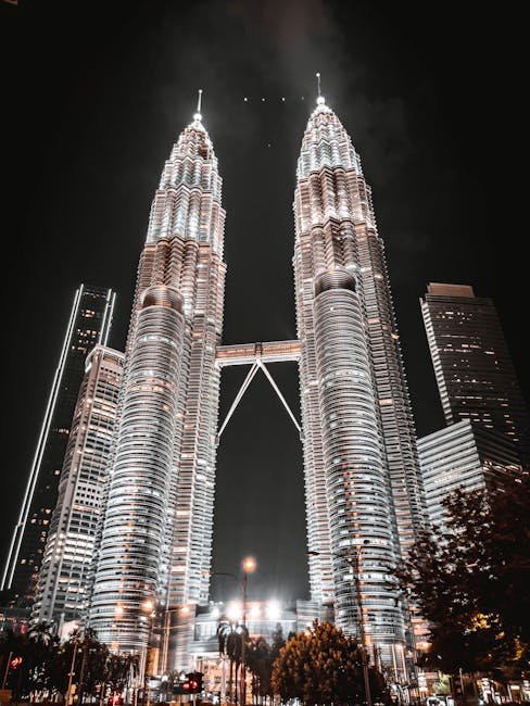 Dramatic night view of Petronas Twin Towers in Kuala Lumpur, Malaysia.